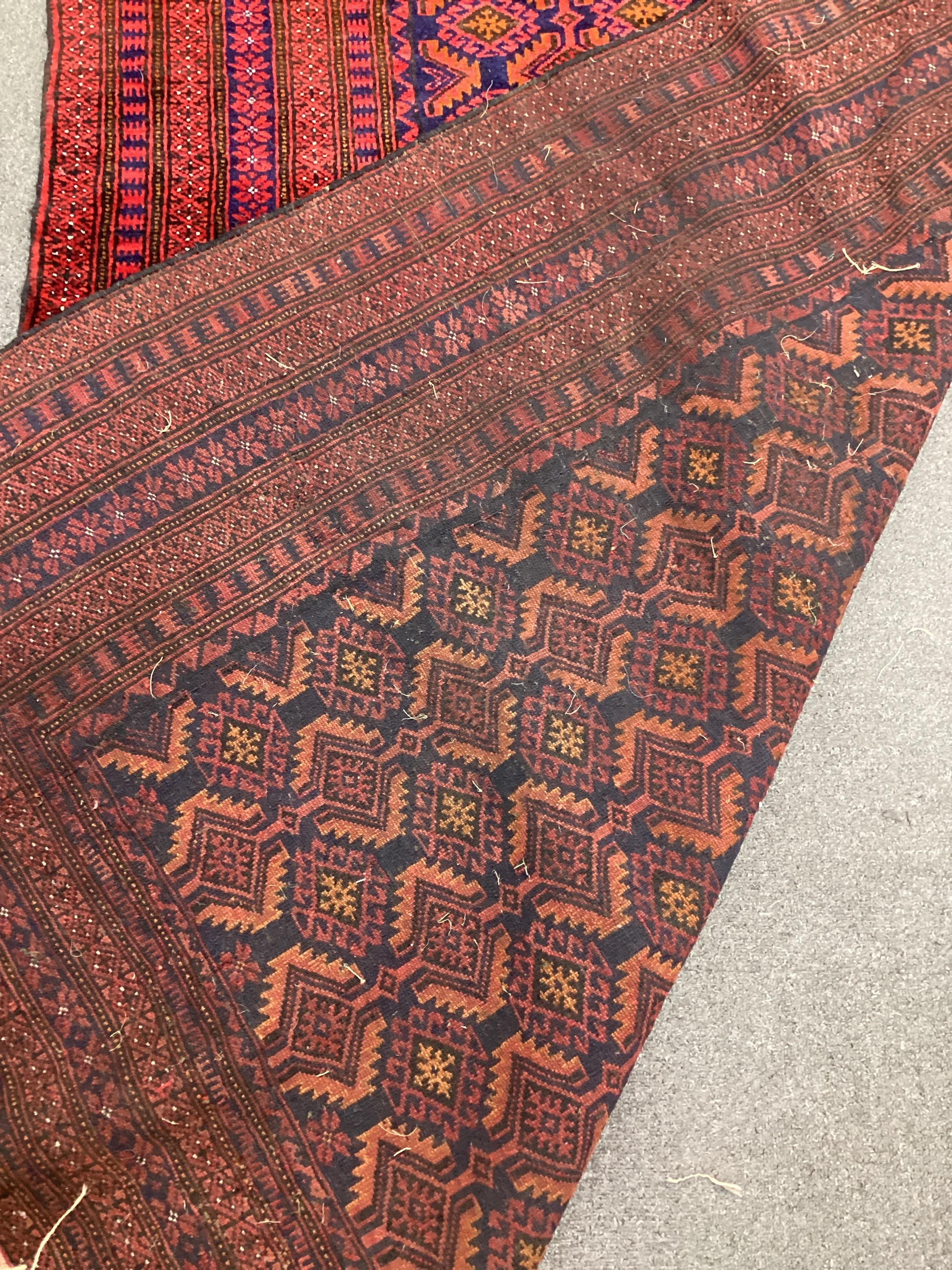 An Afghan blue ground rug, 216cm x 130cm